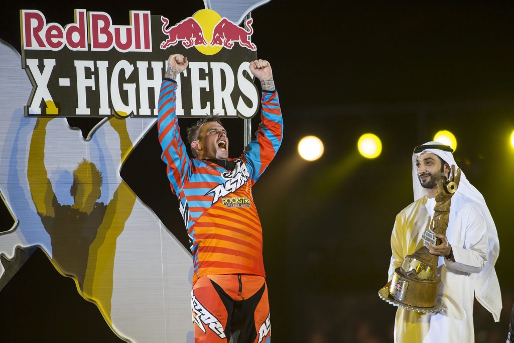 epa05004612 A photograph made avaiable by Global Newsroom on 31 October 2015 showing New World Tour winner Clinton Moore of Australia reacting at the prize giving at the Red Bull X-Fighters in Abu Dhabi, UAE, on 30 October, 2015 with Mohamad Khalifa al Mubarak, chairman of Abu Dhabi Tourism and Culture Authority hands over the trophy. EPA/NAIM CHIDIAC / GLOBAL NEWSROOM / HANDOUT HANDOUT EDITORIAL USE ONLY/NO SALES epa05004612 A photograph made avaiable by Global Newsroom on 31 October 2015 showing New World Tour winner Clinton Moore of Australia reacting at the prize giving at the Red Bull X-Fighters in Abu Dhabi, UAE, on 30 October, 2015 with Mohamad Khalifa al Mubarak, chairman of Abu Dhabi Tourism and Culture Authority hands over the trophy. EPA/NAIM CHIDIAC / GLOBAL NEWSROOM / HANDOUT HANDOUT EDITORIAL USE ONLY/NO SALES